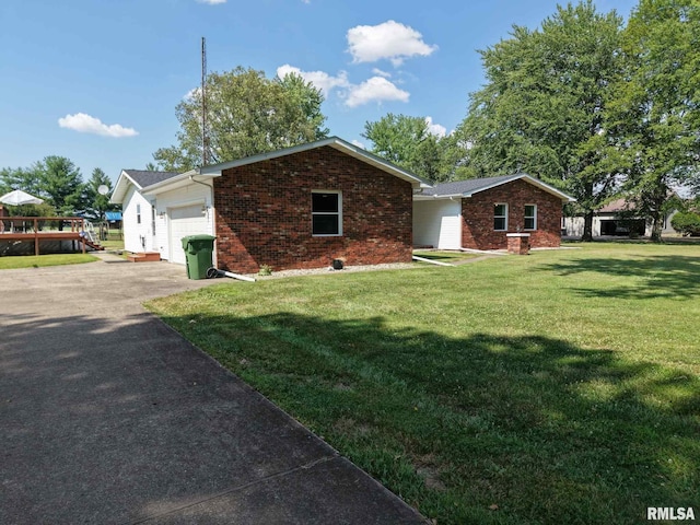13607 Leisure Ln, Benton, IL 62812 - view of home's exterior with brick siding, a garage, driveway, and a lawn