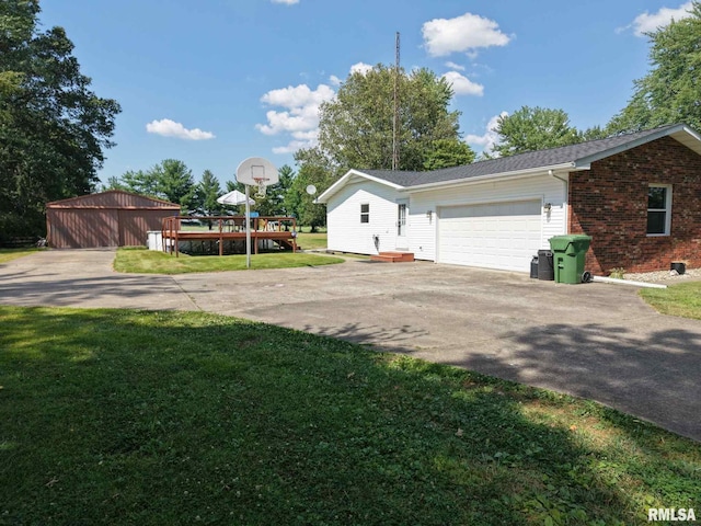 13607 Leisure Ln, Benton, IL 62812 - view of property exterior featuring asphalt driveway, a lawn, a garage, and brick siding