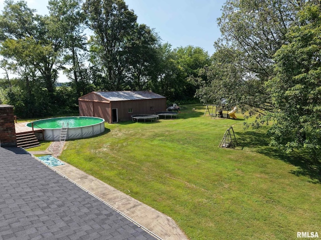 13607 Leisure Ln, Benton, IL 62812 - view of green lawn featuring a trampoline and an outdoor pool
