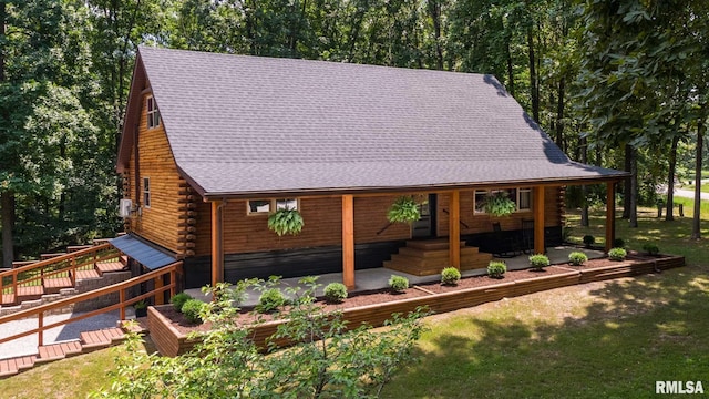 14682 White Birch Ct, Benton, IL 62812 - view of front facade with log siding, a front lawn, a garden, and a shingled roof
