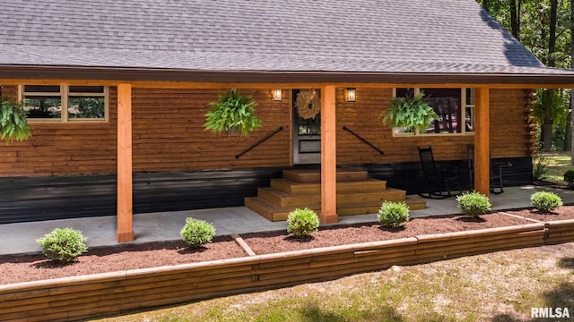 14682 White Birch Ct, Benton, IL 62812 - view of front facade featuring a shingled roof, entry steps, a patio, and log siding