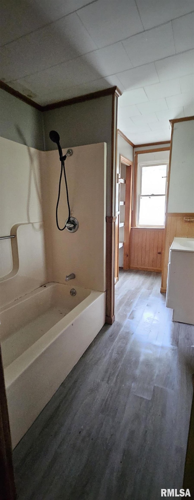 22776 Olive St, Olive Branch, IL 62969 - bathroom featuring shower / tub combination, wood finished floors, wooden walls, and vanity