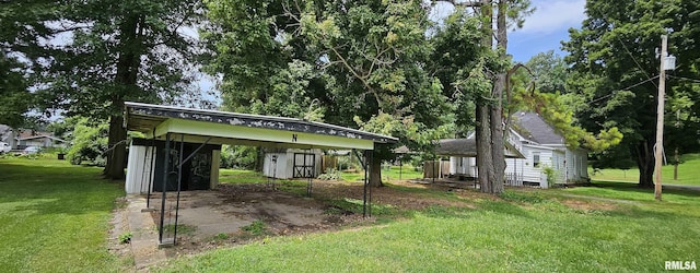 22776 Olive St, Olive Branch, IL 62969 - view of front of property featuring a storage unit, a carport, and a front yard