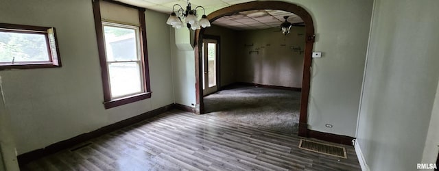 22776 Olive St, Olive Branch, IL 62969 - unfurnished room with arched walkways, a paneled ceiling, wood finished floors, and a chandelier