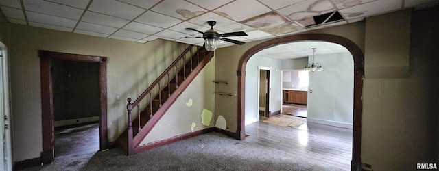 22776 Olive St, Olive Branch, IL 62969 - unfurnished room featuring arched walkways, stairs, a ceiling fan, a chandelier, and a drop ceiling