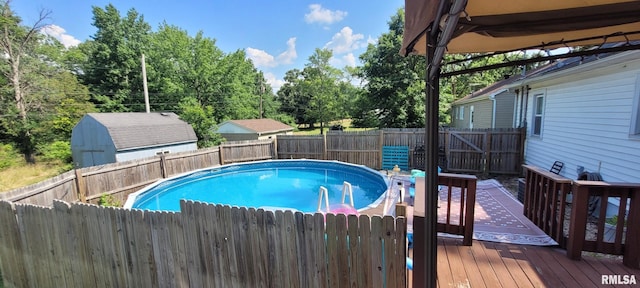 1420 N 17th St, Mount Vernon, IL 62864 - view of pool featuring a deck, a fenced backyard, and a shed