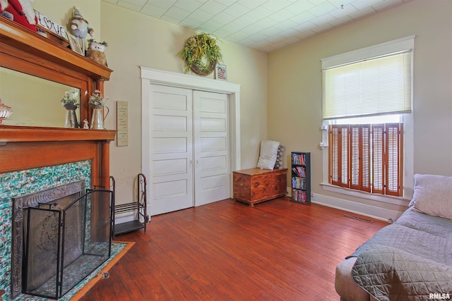827 W Raymond St, Harrisburg, IL 62946 - sitting room with wood-type flooring and a tiled fireplace