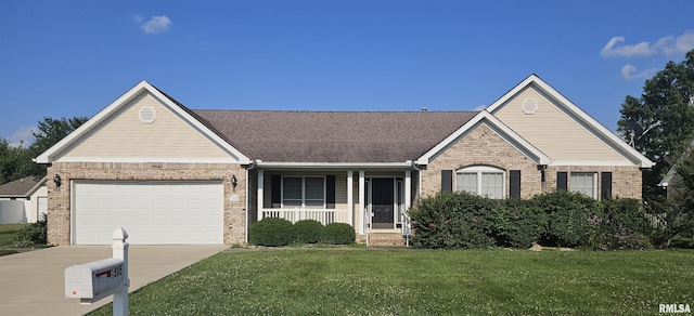 1905 N Dawn Dr, Marion, IL 62959 - single story home with brick siding, a porch, a front lawn, concrete driveway, and an attached garage