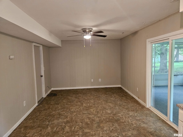 2908 W Kent Dr, Carbondale, IL 62901 - empty room featuring a ceiling fan and wooden walls