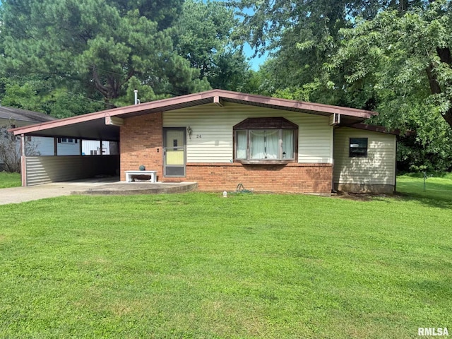 24 Adkins St, Metropolis, IL 62960 - view of front of property featuring brick siding, a front lawn, driveway, and an attached carport