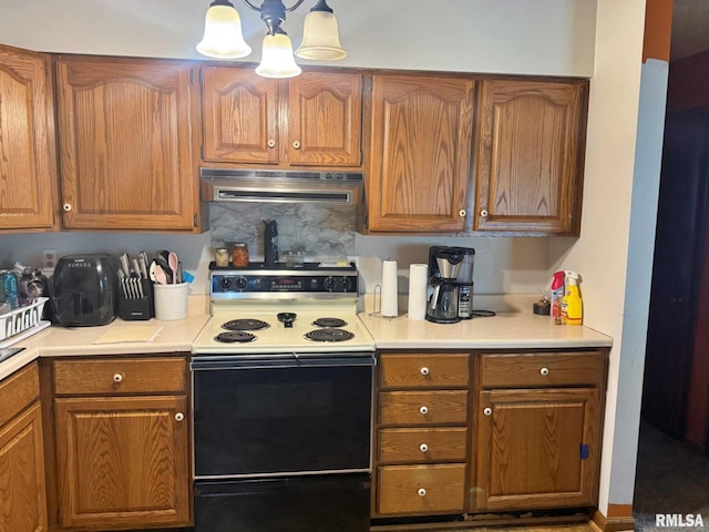 24 Adkins St, Metropolis, IL 62960 - kitchen featuring white electric stove, extractor fan, brown cabinetry, and light countertops