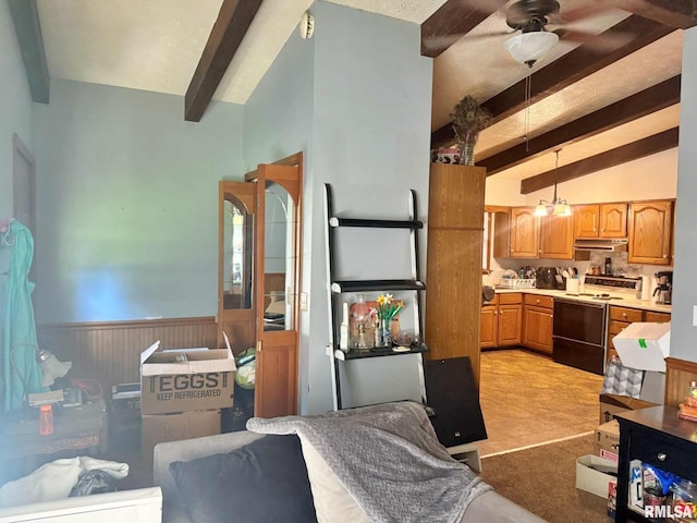 24 Adkins St, Metropolis, IL 62960 - kitchen with white range with electric cooktop, under cabinet range hood, a wainscoted wall, ceiling fan, and hanging light fixtures