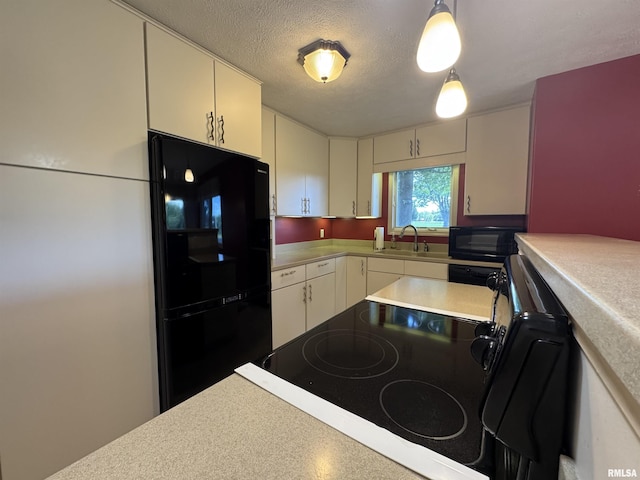 1308 Shawnee Trl, Carterville, IL 62918 - kitchen featuring black appliances, light countertops, white cabinetry, a textured ceiling, and pendant lighting