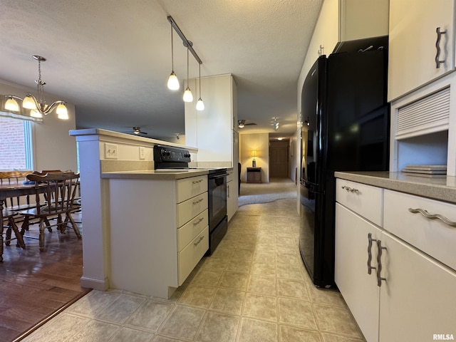 1308 Shawnee Trl, Carterville, IL 62918 - kitchen featuring black appliances, a chandelier, white cabinets, a textured ceiling, and hanging light fixtures