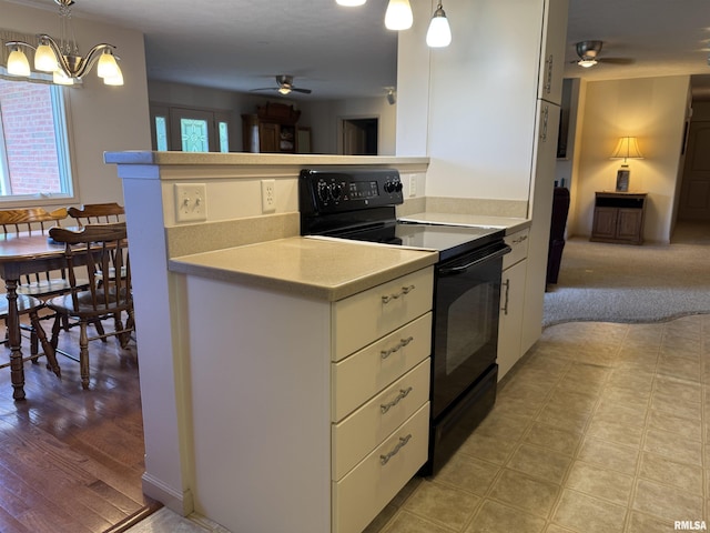 1308 Shawnee Trl, Carterville, IL 62918 - kitchen with electric range, ceiling fan, light countertops, white cabinets, and decorative light fixtures