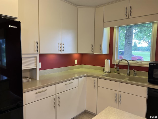 1308 Shawnee Trl, Carterville, IL 62918 - kitchen with black appliances, light countertops, and white cabinetry