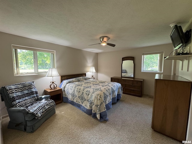 1308 Shawnee Trl, Carterville, IL 62918 - carpeted bedroom featuring multiple windows, ceiling fan, and a textured ceiling