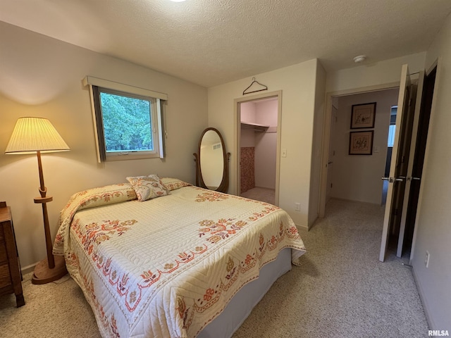 1308 Shawnee Trl, Carterville, IL 62918 - bedroom featuring light colored carpet, a textured ceiling, a closet, and a spacious closet