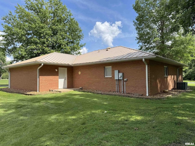 1308 Shawnee Trl, Carterville, IL 62918 - rear view of house with a yard, brick siding, and a metal roof