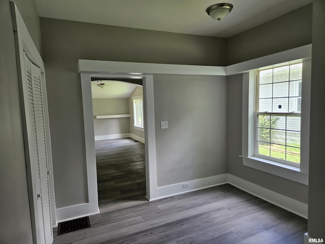 1206 N 14th St, Murphysboro, IL 62966 - unfurnished bedroom featuring wood finished floors and arched walkways