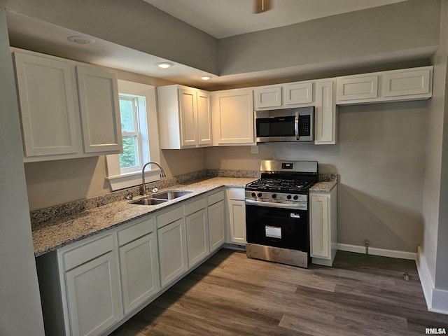 1206 N 14th St, Murphysboro, IL 62966 - kitchen featuring stainless steel appliances, light stone counters, white cabinetry, dark wood-style flooring, and recessed lighting