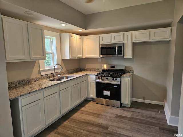 1206 N 14th St, Murphysboro, IL 62966 - kitchen featuring stainless steel appliances, light stone counters, white cabinetry, dark wood-style flooring, and ceiling fan