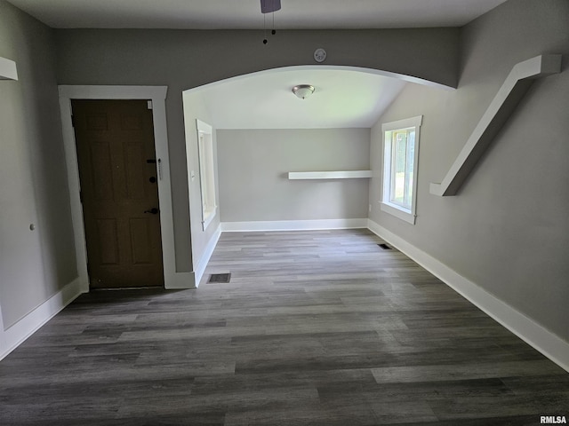 1206 N 14th St, Murphysboro, IL 62966 - unfurnished dining area with arched walkways, lofted ceiling, dark wood-type flooring, and a ceiling fan