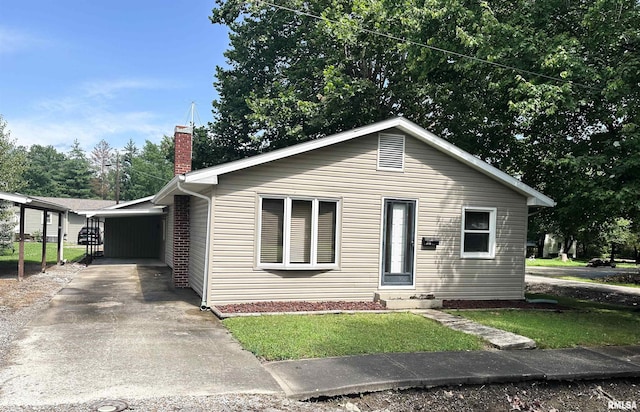 215 S Sunny Slope St, West Frankfort, IL 62896 - view of front of house with a chimney, driveway, a front yard, and entry steps