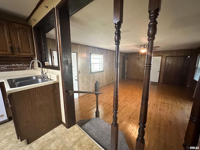 215 S Sunny Slope St, West Frankfort, IL 62896 - kitchen featuring light countertops, wood walls, light wood-style flooring, and dark brown cabinets