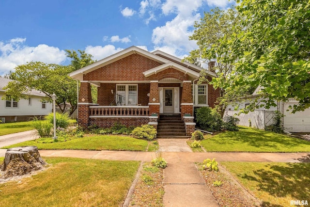 2011 Logan St, Murphysboro, IL 62966 - view of front of home featuring brick siding, a front lawn, and a porch