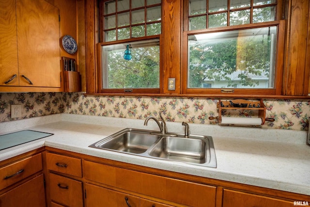 2011 Logan St, Murphysboro, IL 62966 - kitchen with light countertops, brown cabinetry, and wallpapered walls