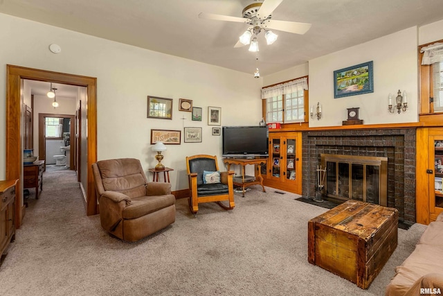 2011 Logan St, Murphysboro, IL 62966 - living area with carpet, a brick fireplace, a ceiling fan, and plenty of natural light