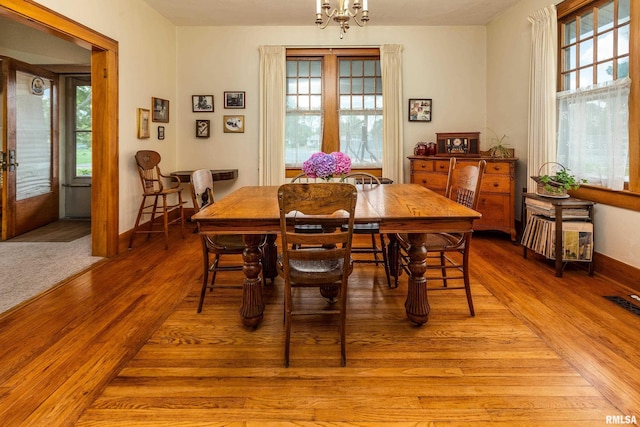 2011 Logan St, Murphysboro, IL 62966 - dining space with light wood-style flooring and a chandelier