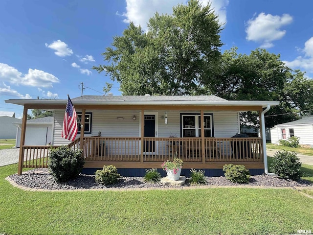 204 Oak St, Odin, IL 62870 - single story home featuring a porch, a front lawn, a garage, and driveway