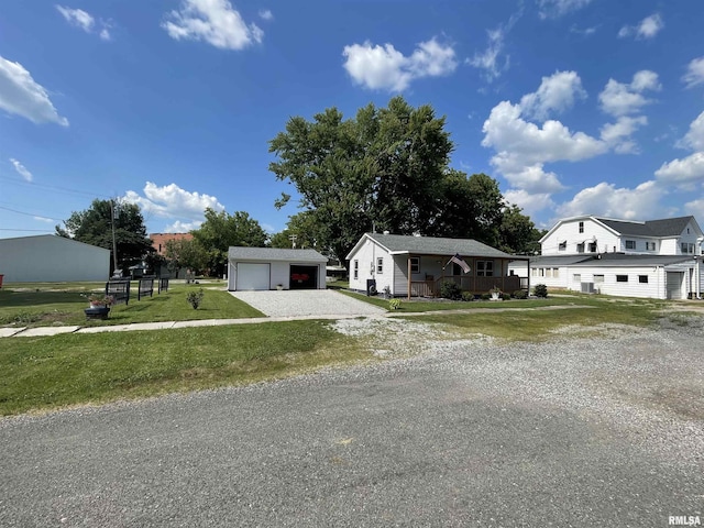 204 Oak St, Odin, IL 62870 - view of front of property featuring an outbuilding, a detached garage, and a front lawn