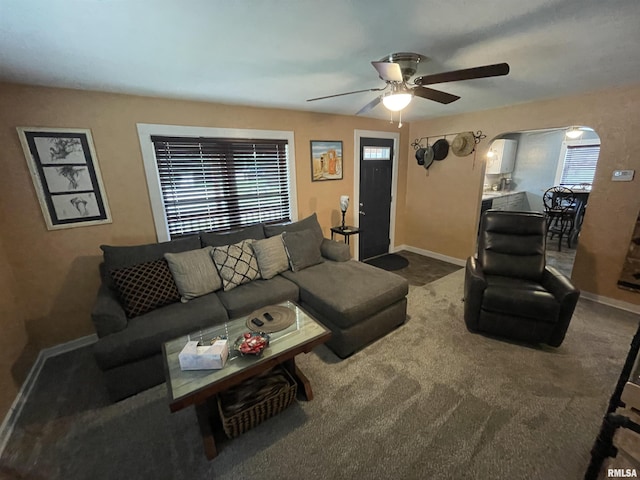 204 Oak St, Odin, IL 62870 - carpeted living room with ceiling fan, arched walkways, and healthy amount of natural light