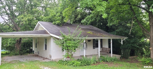 1412 N 11th St, Mount Vernon, IL 62864 - view of front of home featuring a carport, covered porch, and roof with shingles