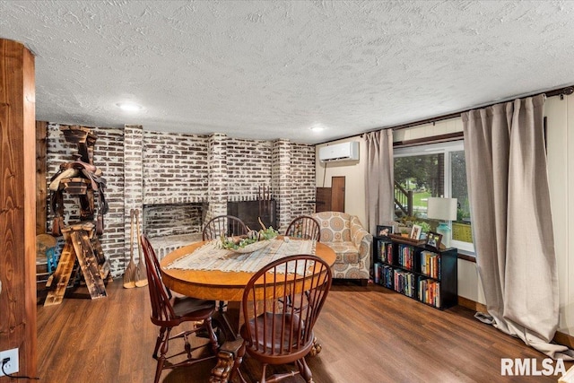 468 Clifty Heights Dr, Marion, IL 62959 - dining space featuring wood finished floors, a textured ceiling, a wall unit AC, a brick fireplace, and brick wall