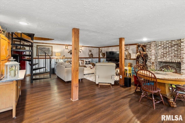 468 Clifty Heights Dr, Marion, IL 62959 - dining space featuring wood finished floors, a textured ceiling, and a brick fireplace