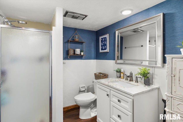 468 Clifty Heights Dr, Marion, IL 62959 - bathroom featuring vanity, a shower stall, wood finished floors, wainscoting, and wallpapered walls