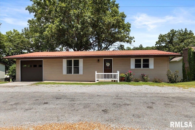 468 Clifty Heights Dr, Marion, IL 62959 - ranch-style home with a porch, an attached garage, gravel driveway, and a metal roof