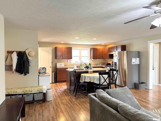 501 Cedar Creek Rd, Makanda, IL 62958 - kitchen featuring stainless steel refrigerator with ice dispenser, ceiling fan, light countertops, light wood finished floors, and a center island