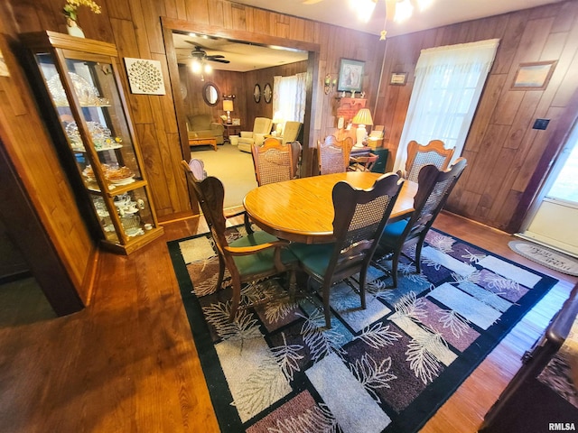 113 SW Mead St, Clay City, IL 62824 - dining space with ceiling fan, wooden walls, and wood finished floors