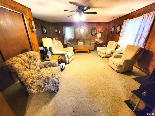 113 SW Mead St, Clay City, IL 62824 - carpeted living room with plenty of natural light, a ceiling fan, wood walls, and a textured ceiling