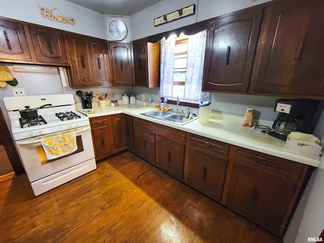 113 SW Mead St, Clay City, IL 62824 - kitchen featuring white range with gas cooktop, light countertops, wood finished floors, and dark brown cabinetry