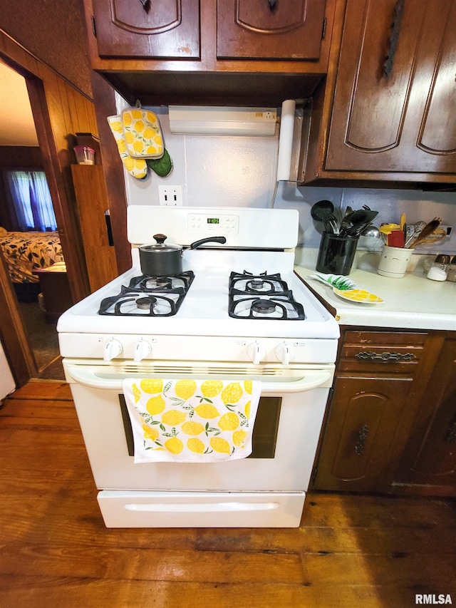 113 SW Mead St, Clay City, IL 62824 - kitchen featuring white range with gas stovetop, light countertops, and dark wood-type flooring