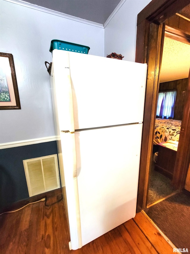 113 SW Mead St, Clay City, IL 62824 - kitchen featuring freestanding refrigerator, wood finished floors, and ornamental molding