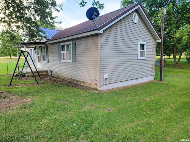 113 SW Mead St, Clay City, IL 62824 - view of side of property featuring a yard and a metal roof
