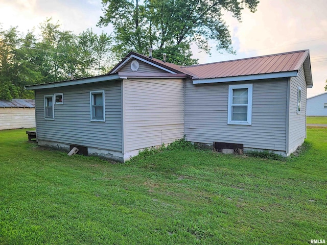 113 SW Mead St, Clay City, IL 62824 - view of home's exterior featuring a metal roof and a lawn