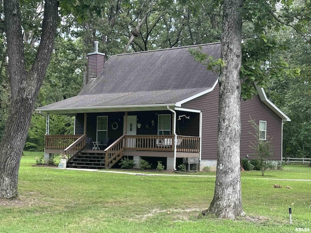 11382 Petroff Rd, Benton, IL 62812 - view of front facade featuring a chimney, a front yard, covered porch, and a shingled roof